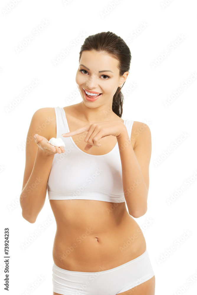 Happy woman applying shaving foam on her face Happy woman applying shaving foam on her face