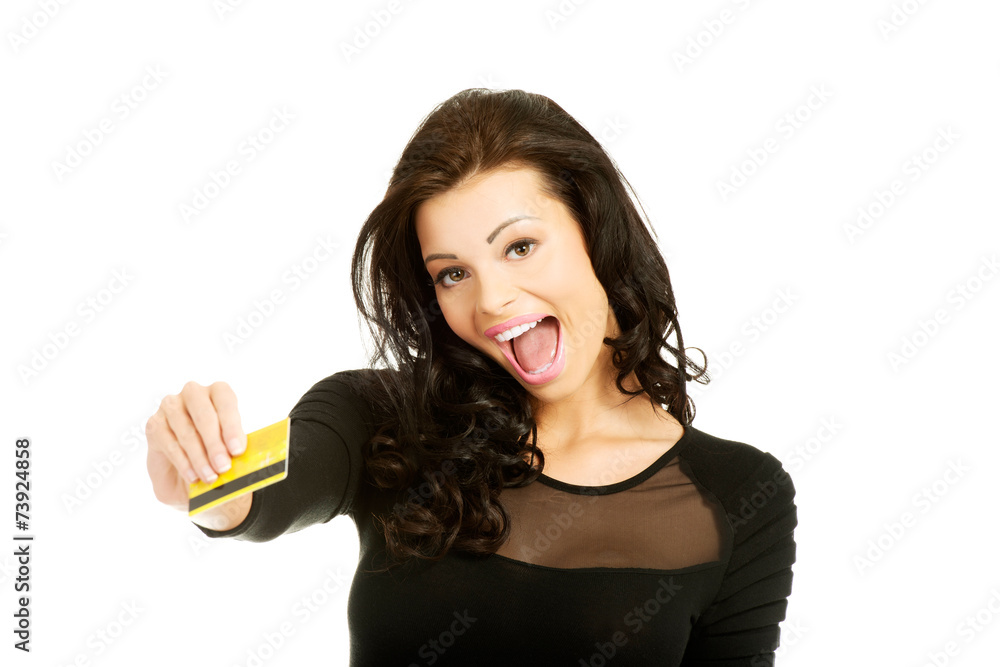 Happy cheerful woman holding credit card Happy cheerful woman holding credit card