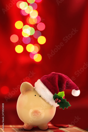 Christmas Piggy bank Santa with festive bokeh background