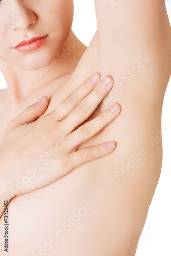 Close up on woman touching an armpit