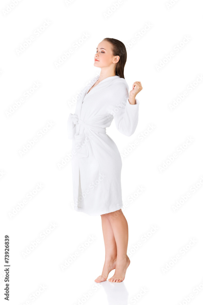 Side view woman standing, wearing bathrobe Side view woman standing, wearing bathrobe