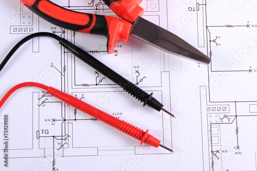 Cables of multimeter and work tool on construction drawing