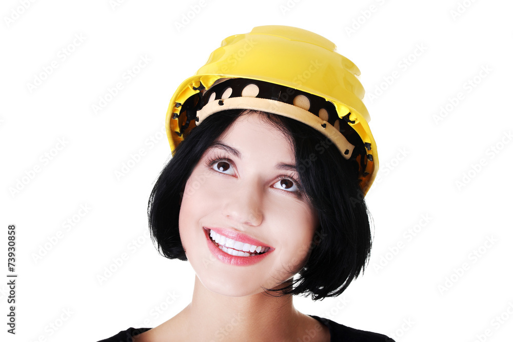 Portrait of a woman with hardhat looking up Portrait of a woman with hardhat looking up
