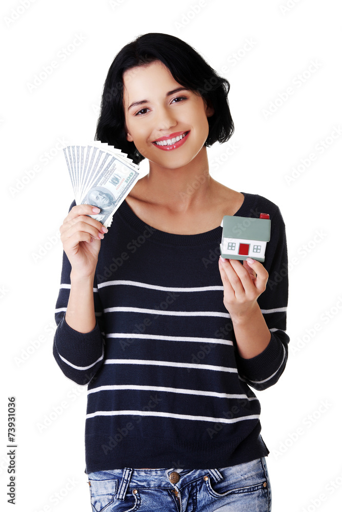 Happy woman holding a house model and dollar bills Happy woman holding a house model and dollar bills