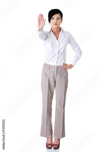 Full length of a woman showing stop sign