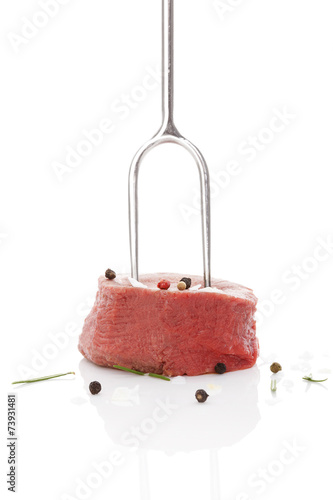 Raw steak on fork. photo