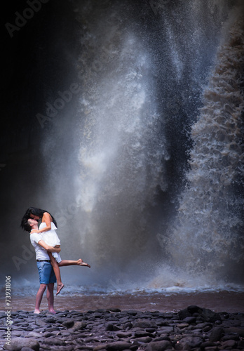 couple travel near the waterfall