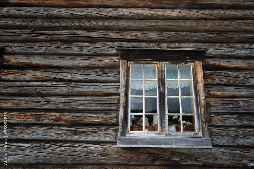 Dark timbered wooden wall with white window