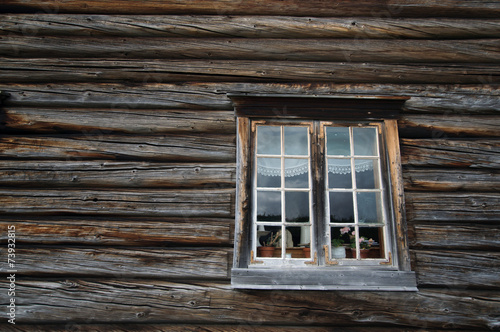 Dark timbered wooden wall with white window