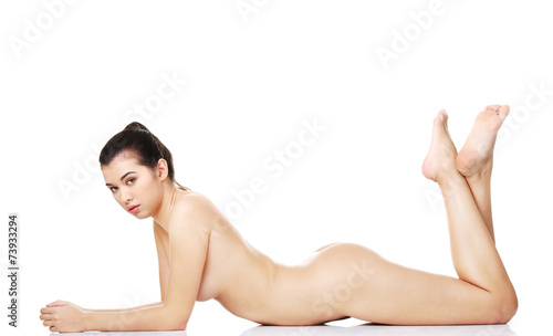 Beautiful naked woman lying on belly