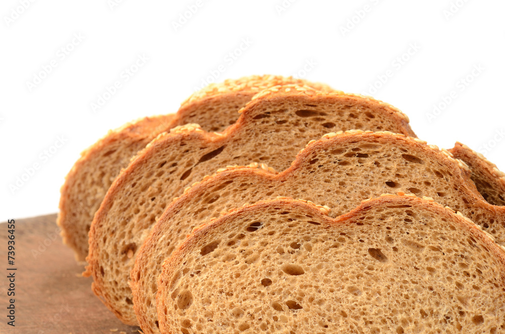 sliced loaf of bread on a cutting board isolated on white