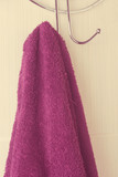 Maroon towel hanging on a hook