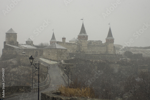 Old tower in Kamianets-Podilskyi with yte lights, Ukraine photo