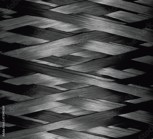 Texture of Carbon Kevlar Fiber material. Dark background