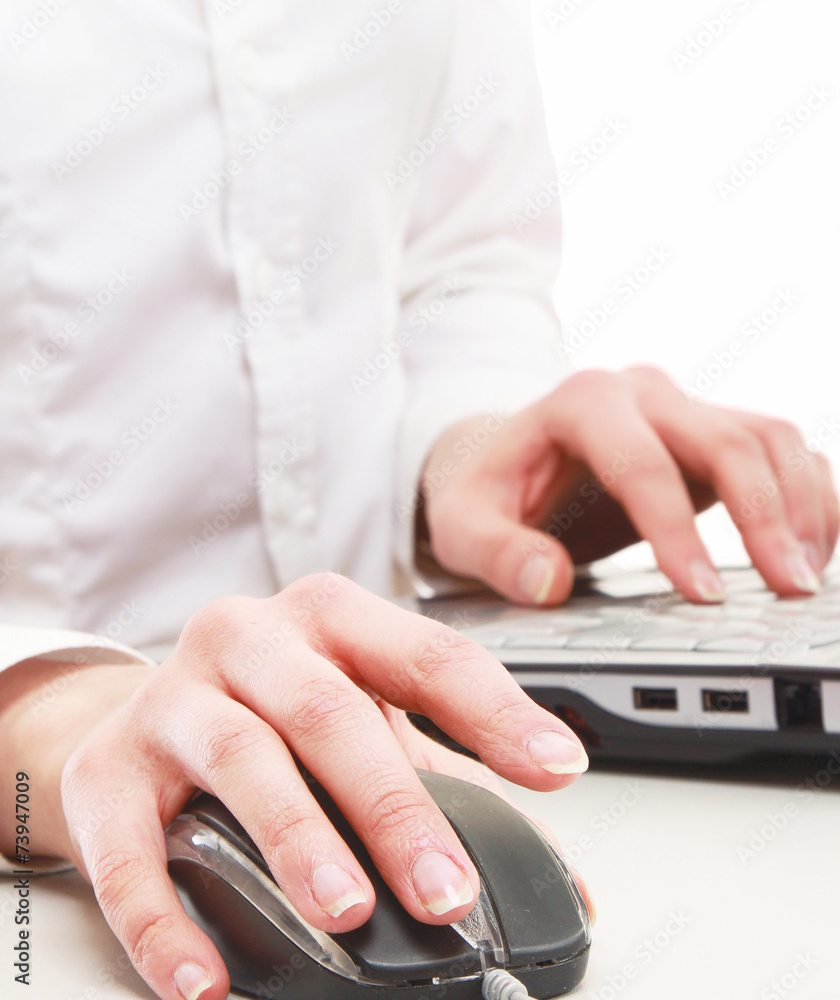 A young businesswoman working on a laptop, focus on her hands A young businesswoman working on a laptop, focus on her hands