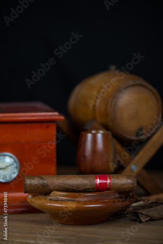 Cuban cigar in ashtray with humidor and rum barrel © marcin jucha