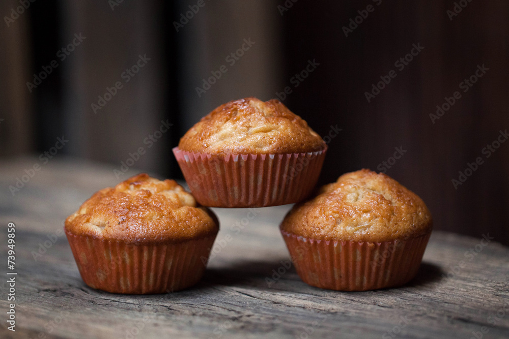 delicious homemade muffins over wooden board