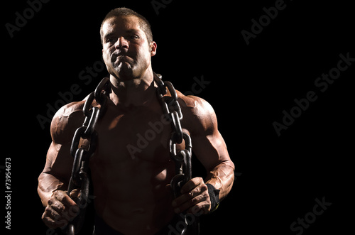 Muscular athlete with chains © Video Image Guy