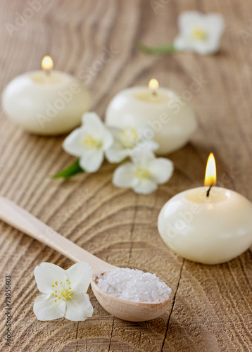 Spa composition with sea salt bath, jasmine flowers and candles