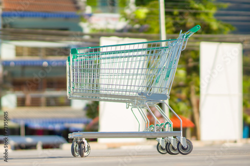 Two shopping cart on parking lot near supermarket