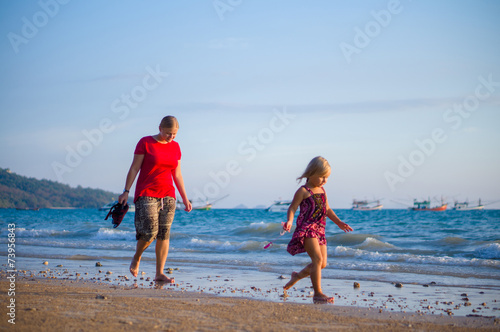 Mother and daughter walk along the beach