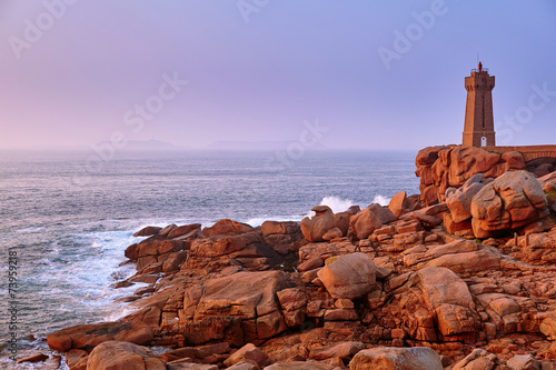 Scenic view of pink granite coast at sunset