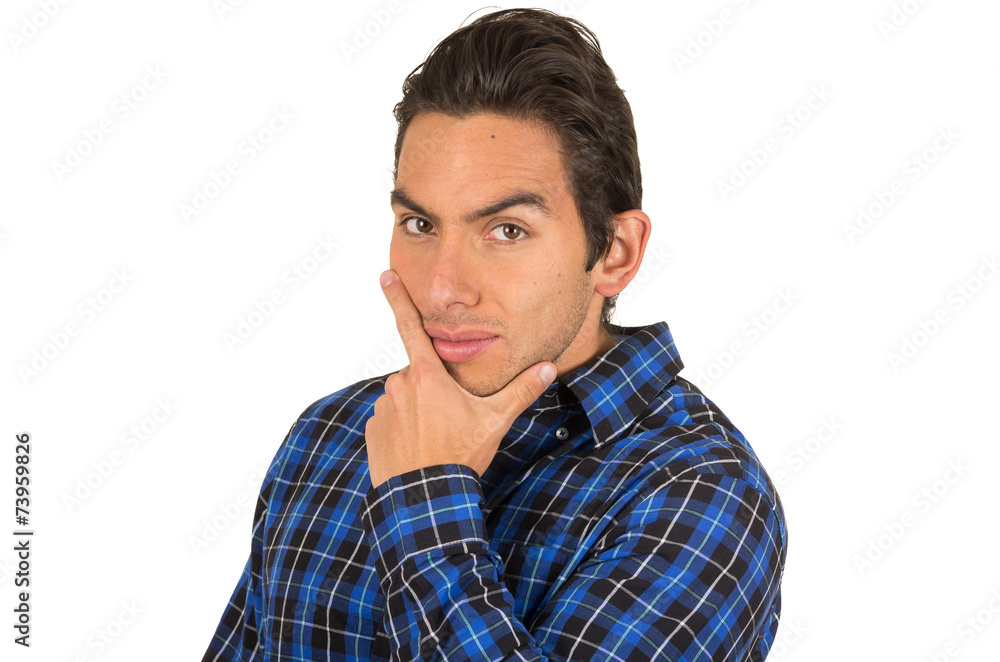 handsome young latin man wearing a blue plaid shirt posing with