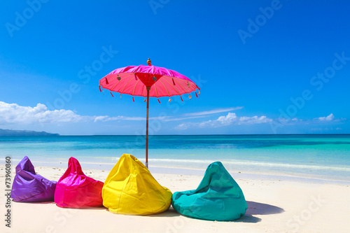 colorful pillows and bright umbrella on tropical sea and beach b © Alena Yakusheva