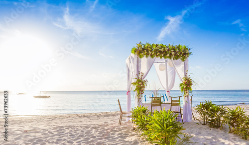 wedding arch and set up on beach, tropical outdoor wedding caban