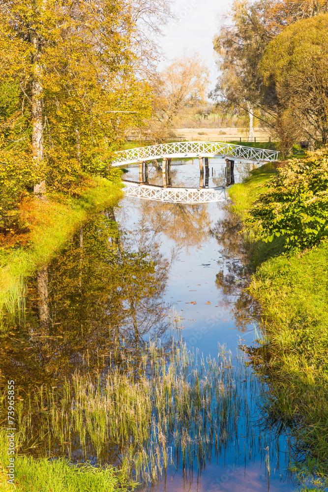 The clouds and the bridge reflected in the pond The clouds and the bridge reflected in the pond