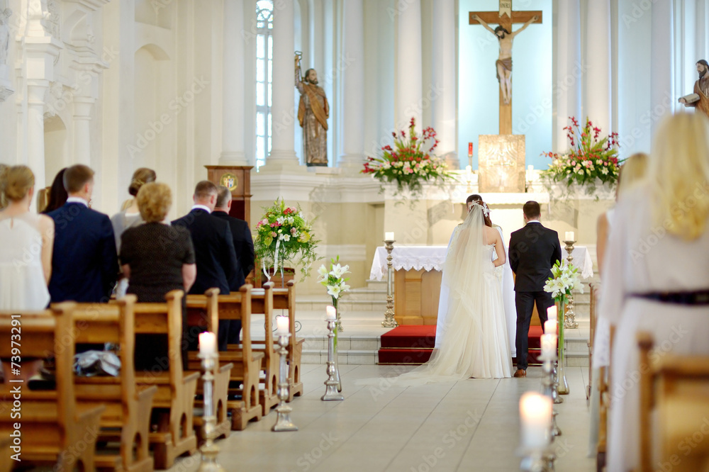 Fototapeta premium Bride and groom at the church during a wedding