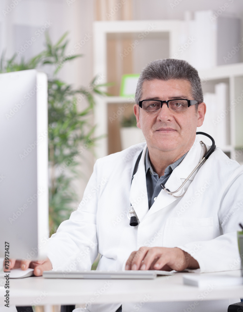 smiling modern senior doctor with glasses in the office smiling modern senior doctor with glasses in the office