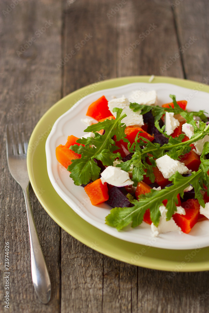 salad of roasted beets and pumpkin with feta cheese and arugula