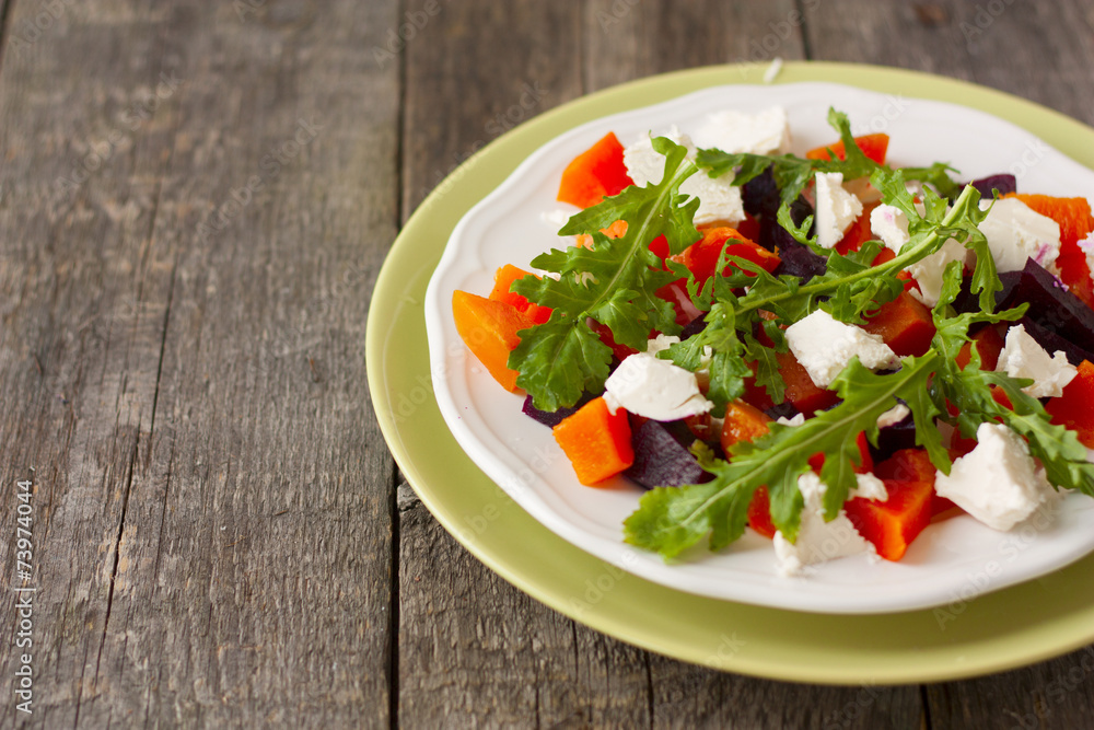 salad of roasted beets and pumpkin with feta cheese and arugula