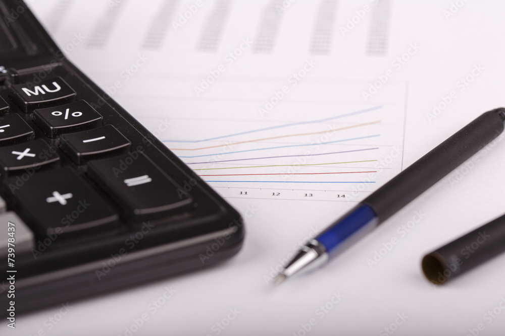 Business Charts with calculator and pen Business Charts with calculator and pen