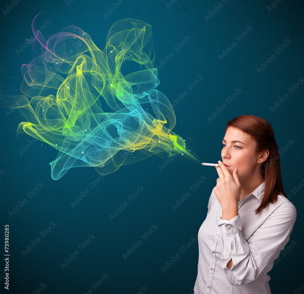 Fototapeta premium Pretty lady smoking cigarette with colorful smoke