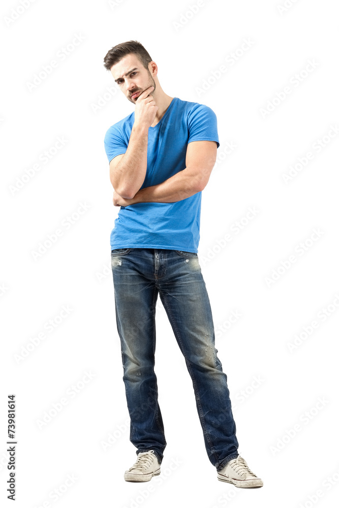 Skeptical young man looking at camera Skeptical young man looking at camera