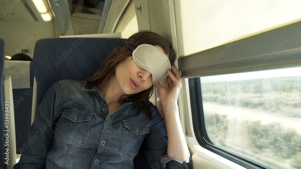 Pretty woman with sleeping eye mask on a train Pretty woman with sleeping eye mask on a train