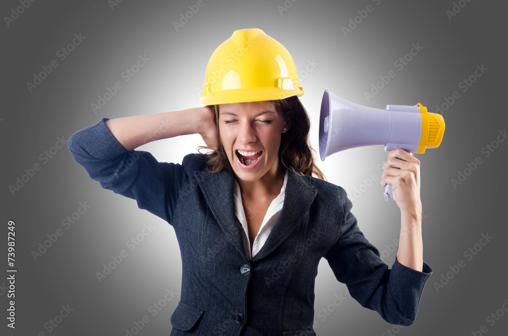 Female construction worker with loudspeaker Female construction worker with loudspeaker