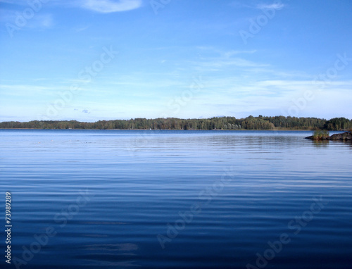 Forest lake under blue cloudy sky, Finland, Europe © elgreko