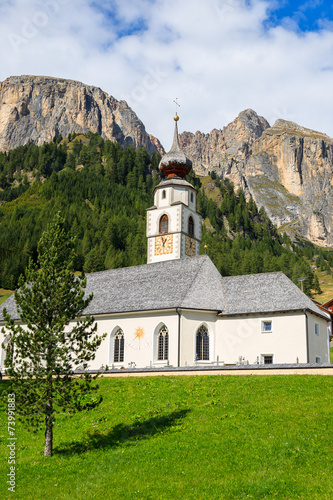 Church in alpine village of Colfosco, Dolomites Mountains, Italy