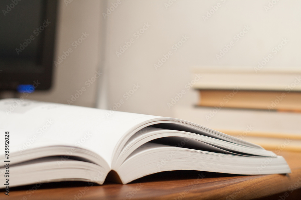 Open book on a work table Open book on a work table