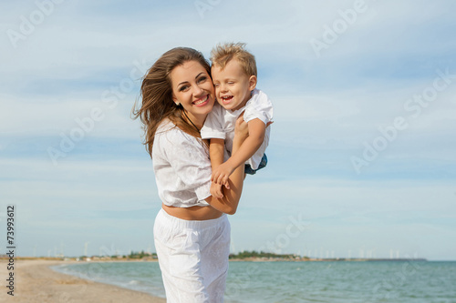 Mother and her son having fun on the beach