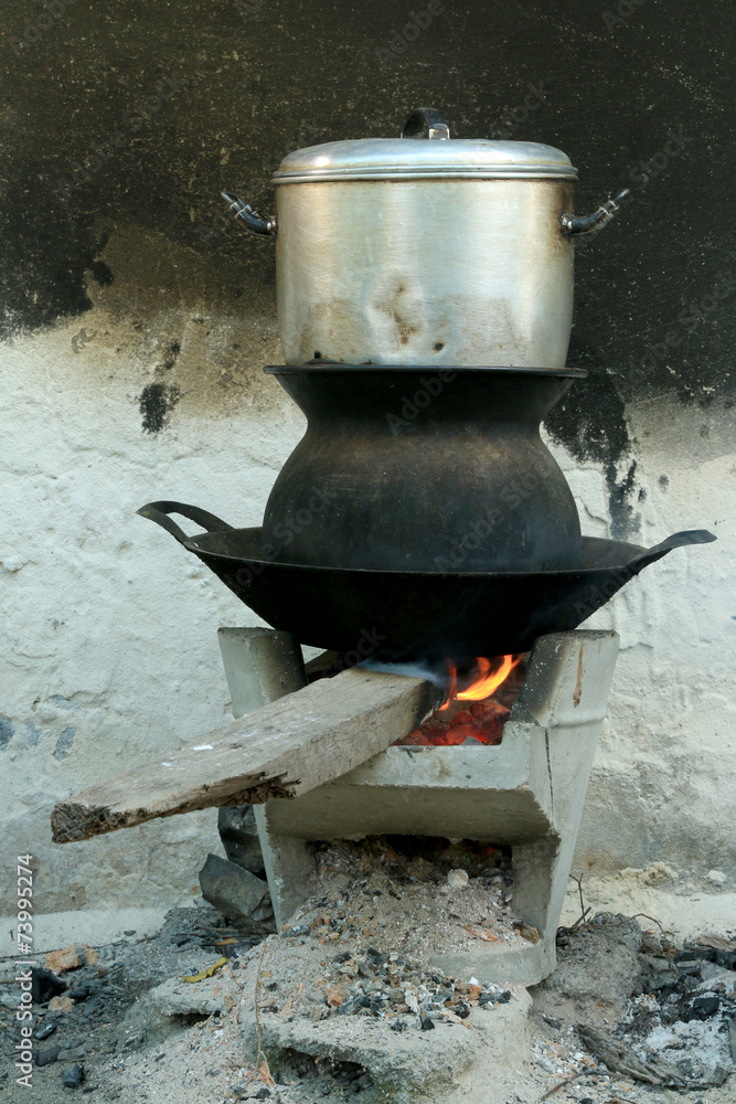 Boil steam pot on bon fire stove Boil steam pot on bon fire stove