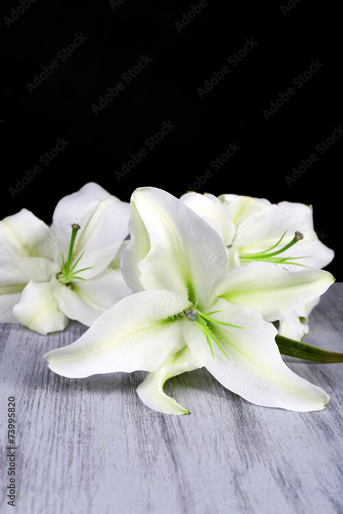 Beautiful lily on wooden table