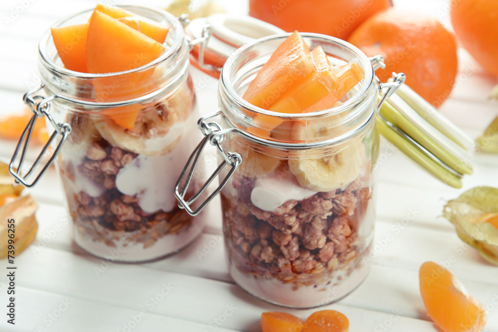 Healthy layered dessert with muesli and fruits on table Healthy layered dessert with muesli and fruits on table