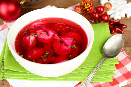 Traditional polish clear red borscht with dumplings and