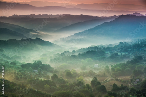 Fog at dawn over the valley in Tuscany