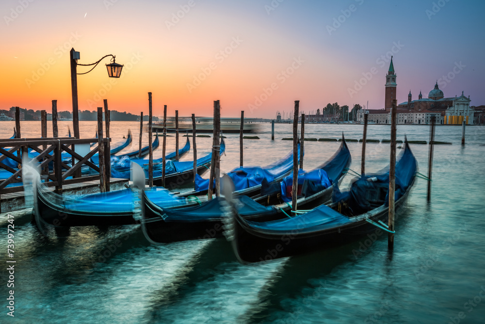 Swinging gondolas in Venice at dawn