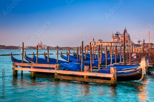 Blue gondolas at sunrise in Venice